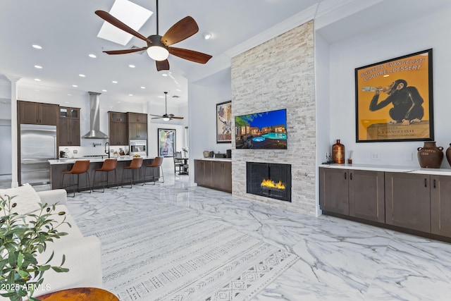 30600 N Pima Rd N Unit 81, Scottsdale, AZ 85266 - living area featuring light marble finish flooring, a ceiling fan, recessed lighting, and a fireplace