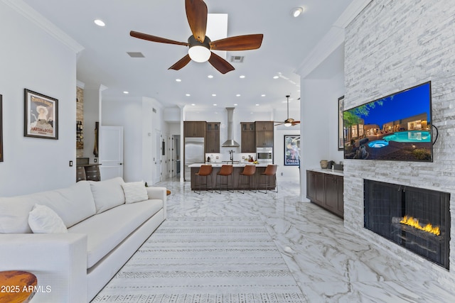 30600 N Pima Rd N Unit 81, Scottsdale, AZ 85266 - living area featuring a ceiling fan, light marble finish floors, crown molding, a stone fireplace, and recessed lighting