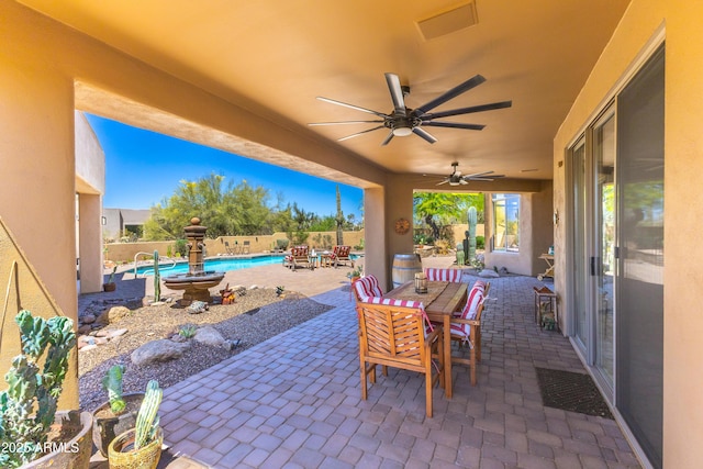 30600 N Pima Rd N Unit 81, Scottsdale, AZ 85266 - view of patio featuring outdoor dining area, a ceiling fan, and a fenced backyard