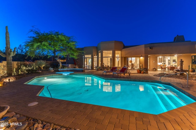 30600 N Pima Rd N Unit 81, Scottsdale, AZ 85266 - pool at night featuring a patio area and a jacuzzi