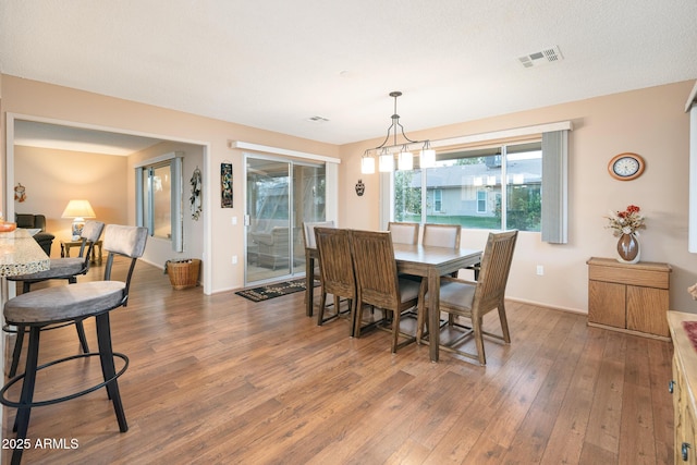 dining space featuring dark wood-type flooring