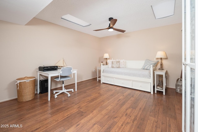 office area with ceiling fan, dark hardwood / wood-style flooring, and a textured ceiling