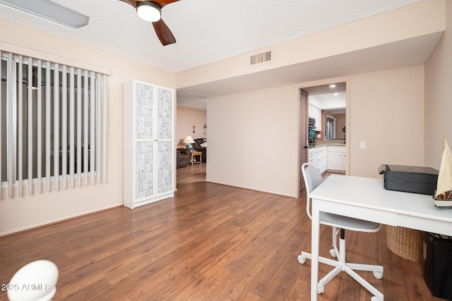 home office with hardwood / wood-style floors, a textured ceiling, and ceiling fan