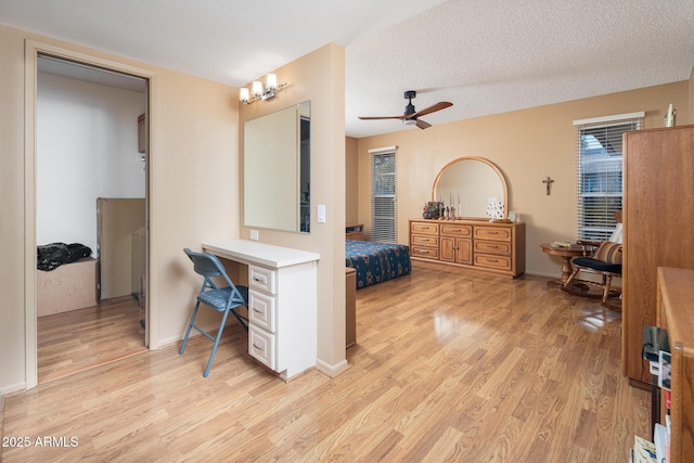 bathroom with a textured ceiling, hardwood / wood-style flooring, and ceiling fan