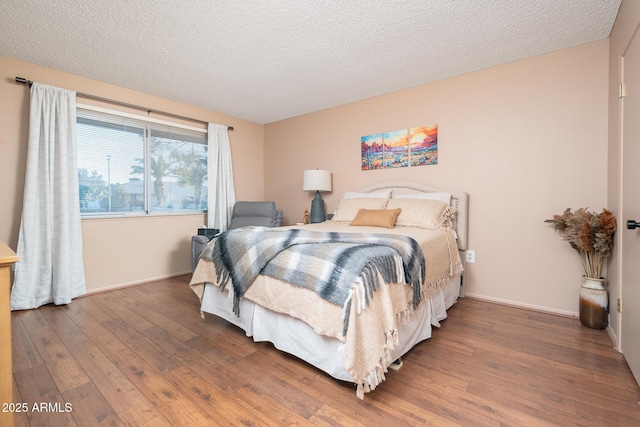 bedroom featuring hardwood / wood-style floors and a textured ceiling