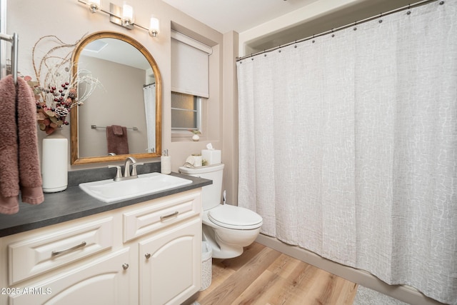 bathroom with vanity, hardwood / wood-style flooring, and toilet