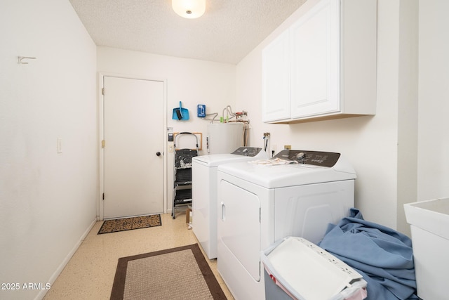 laundry room with separate washer and dryer, electric water heater, cabinets, and a textured ceiling