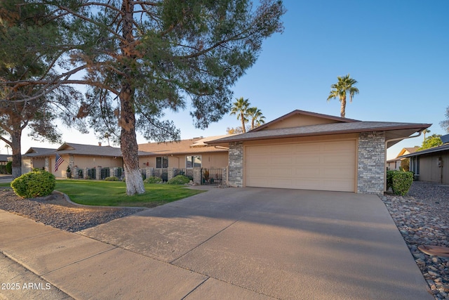 ranch-style home with a garage and a front yard