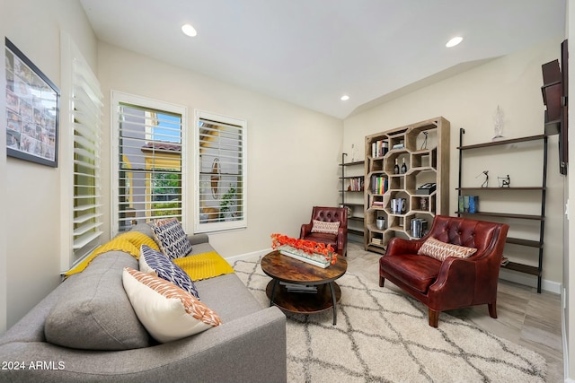 sitting room featuring wood-type flooring and lofted ceiling