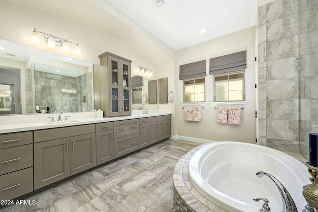 bathroom featuring plus walk in shower and vanity