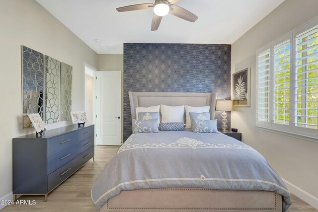 bedroom with ceiling fan and light wood-type flooring