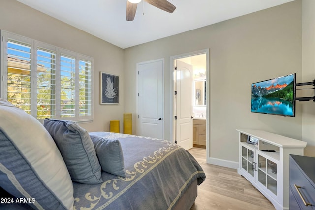 bedroom with ceiling fan, connected bathroom, and light hardwood / wood-style flooring