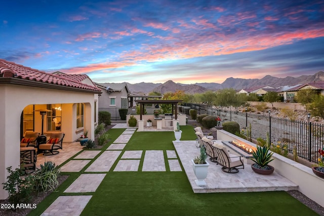 exterior space with a mountain view, exterior kitchen, and an outdoor hangout area