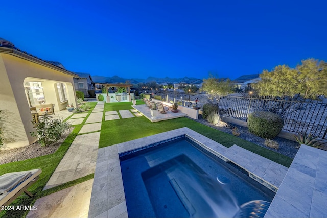 view of swimming pool featuring an in ground hot tub, a patio area, and a lawn