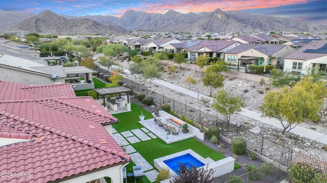 aerial view at dusk featuring a mountain view