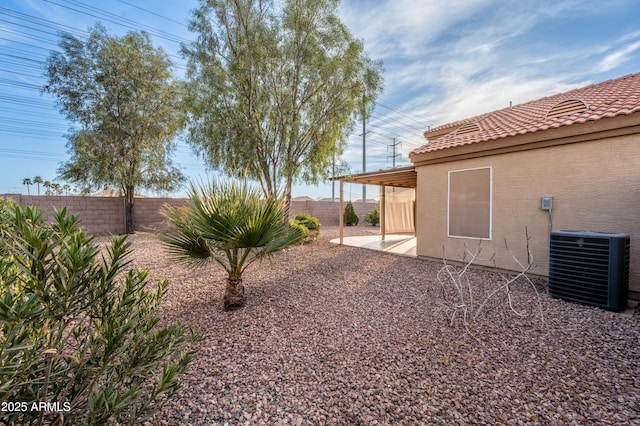 view of yard featuring a patio, a fenced backyard, and cooling unit