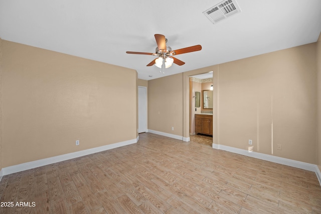 unfurnished bedroom featuring baseboards, visible vents, a ceiling fan, ensuite bathroom, and light wood-style floors