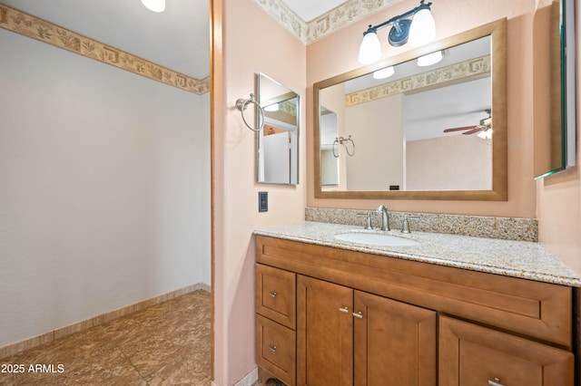 bathroom featuring baseboards, a ceiling fan, and vanity