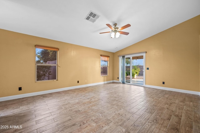 unfurnished room with light wood finished floors, lofted ceiling, visible vents, ceiling fan, and baseboards