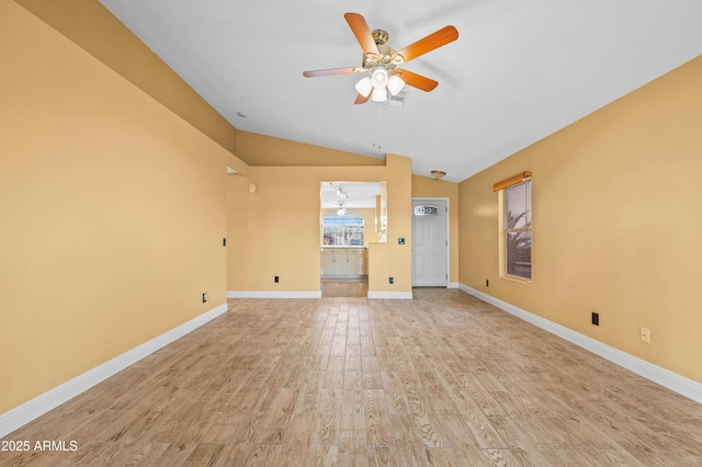 unfurnished living room with lofted ceiling, light wood-type flooring, a ceiling fan, and baseboards