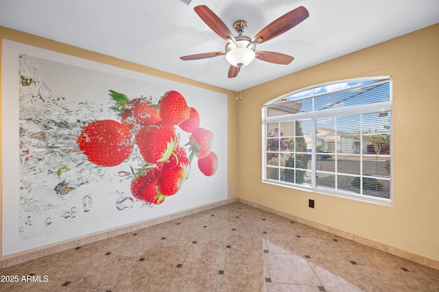 unfurnished room featuring baseboards and a ceiling fan