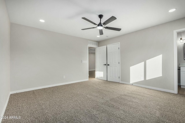 unfurnished bedroom with connected bathroom, ceiling fan, and carpet