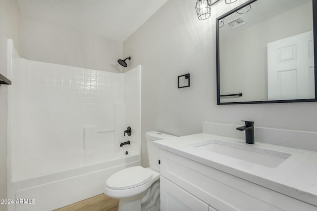 full bathroom featuring hardwood / wood-style floors, vanity, toilet, and shower / bath combination