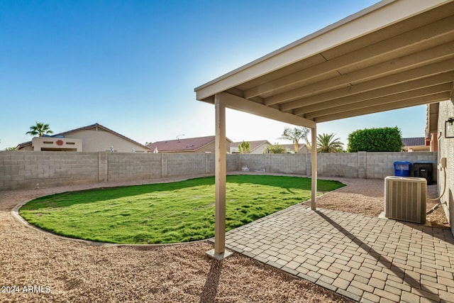 view of yard with cooling unit and a patio area