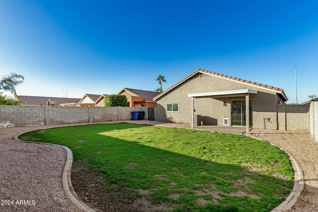 rear view of property with a lawn