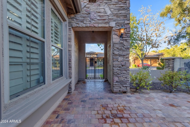 view of exterior entry with a patio