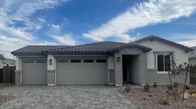 12381 W Marguerite Ave, Avondale, AZ 85323 - single story home with an attached garage, decorative driveway, a tiled roof, and brick siding