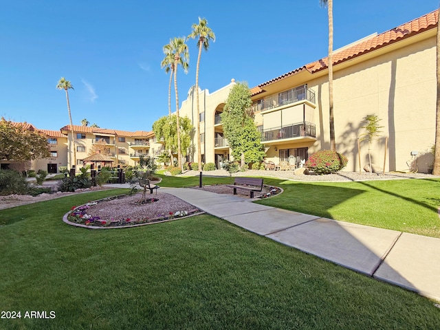 view of home's community with a yard