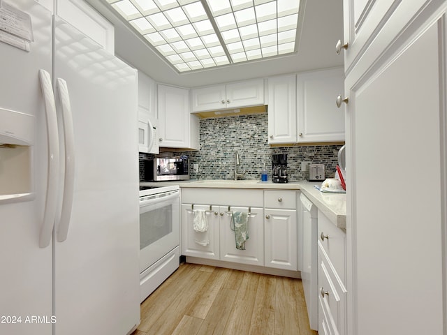 kitchen with white cabinetry, light wood-type flooring, white appliances, and sink