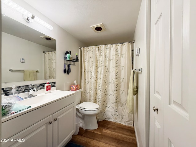 bathroom with hardwood / wood-style floors, vanity, toilet, and tasteful backsplash