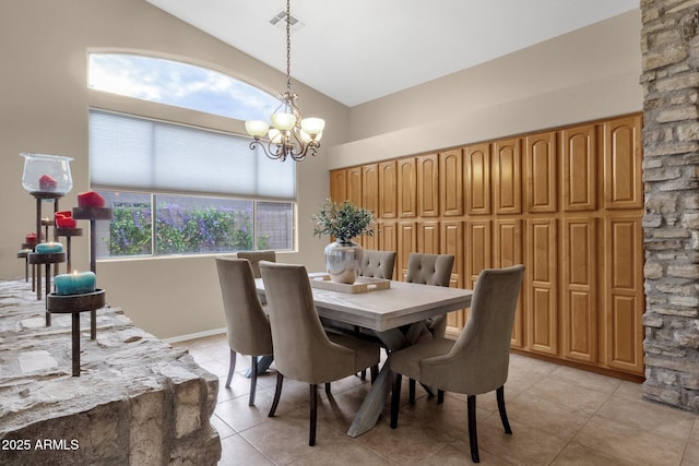 dining area with a chandelier, high vaulted ceiling, and light tile patterned floors