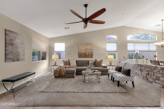 living room featuring lofted ceiling, plenty of natural light, ceiling fan with notable chandelier, and light carpet