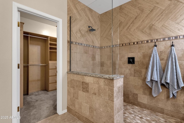 bathroom featuring tiled shower and tile patterned flooring