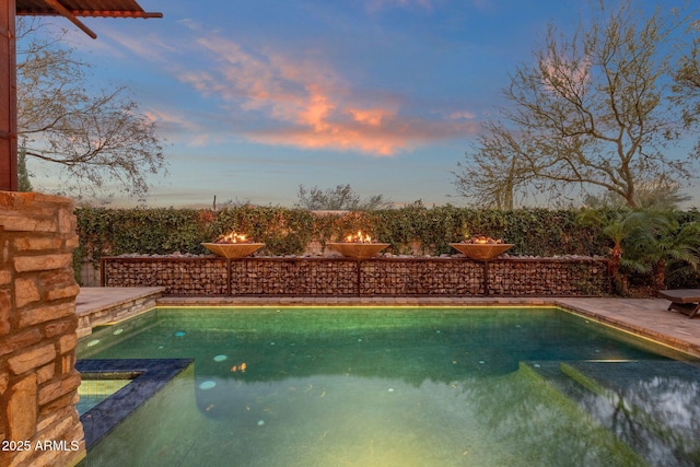 view of pool at dusk