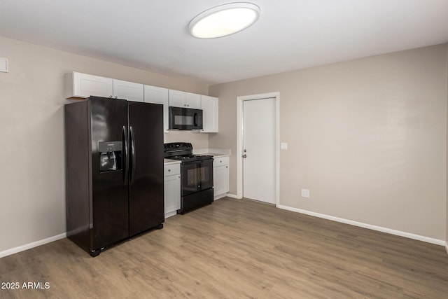 3118 W Aster Dr, Phoenix, AZ 85029 - kitchen with black appliances, light wood-style flooring, and white cabinetry