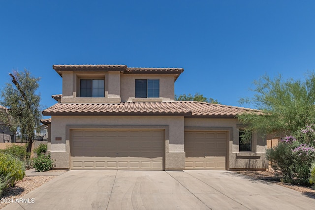 mediterranean / spanish-style home with a garage