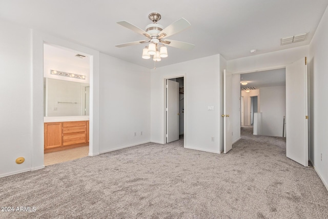 6350 W Hess St, Phoenix, AZ 85043 - unfurnished bedroom featuring a walk in closet, light colored carpet, ceiling fan, and ensuite bathroom