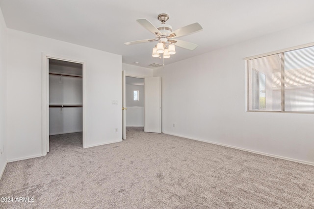 6350 W Hess St, Phoenix, AZ 85043 - unfurnished bedroom with a spacious closet, light carpet, ceiling fan, and a closet
