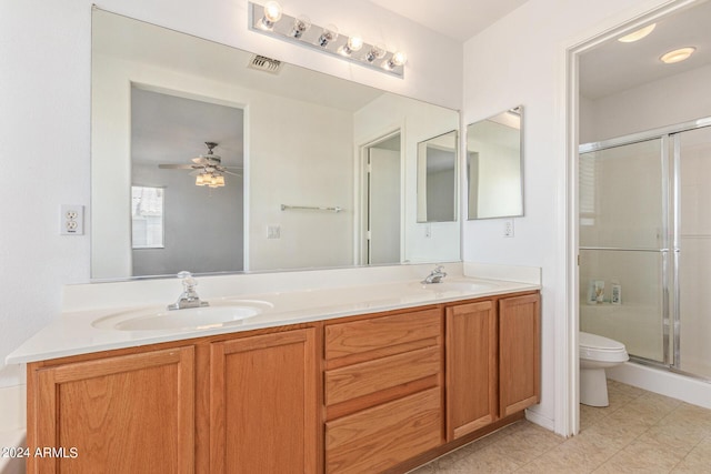 6350 W Hess St, Phoenix, AZ 85043 - bathroom featuring ceiling fan, vanity, toilet, and a shower with shower door
