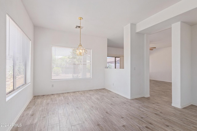 6350 W Hess St, Phoenix, AZ 85043 - unfurnished dining area with a notable chandelier and light hardwood / wood-style flooring