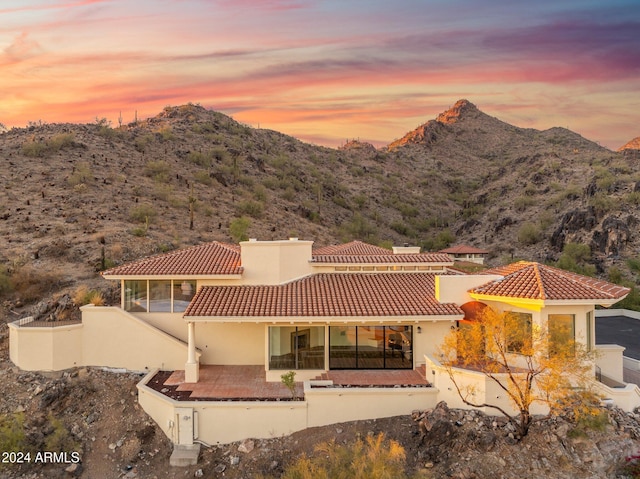 back house at dusk with a mountain view