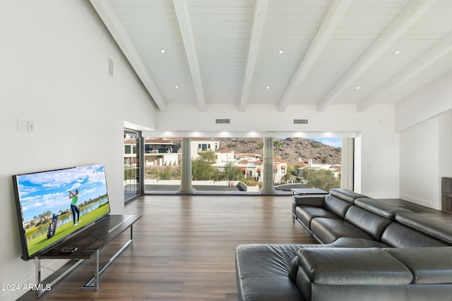 living room featuring beam ceiling, a towering ceiling, wooden ceiling, and dark wood-type flooring