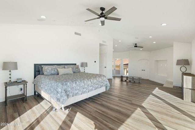 bedroom featuring ceiling fan, dark hardwood / wood-style flooring, and vaulted ceiling