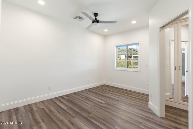 unfurnished room featuring dark hardwood / wood-style floors and ceiling fan