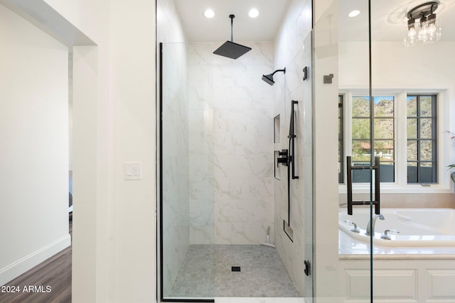 bathroom with hardwood / wood-style floors and plus walk in shower