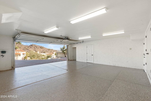 garage featuring a mountain view and a garage door opener